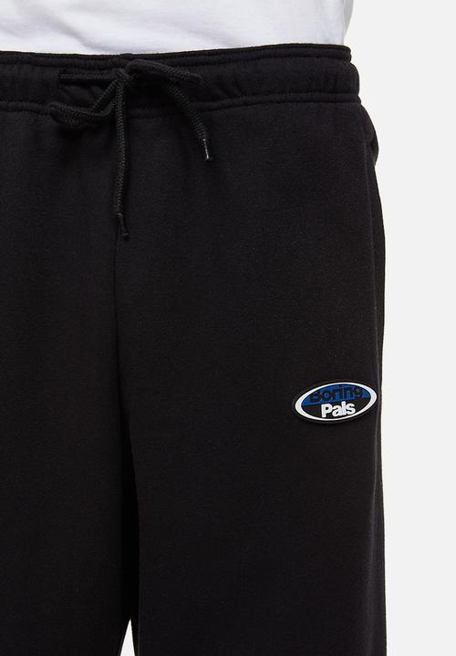 H&M - Relaxed fit printed sweatpants - black/boring pals
