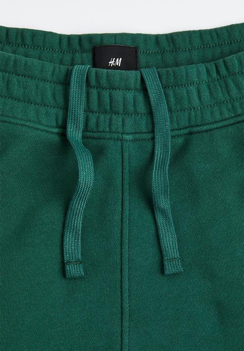 H&M - Loose fit printed sweatpants - dark green/boring pals