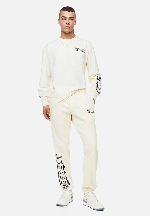 H&M - Regular fit sweatpants - cream/felix the cat 