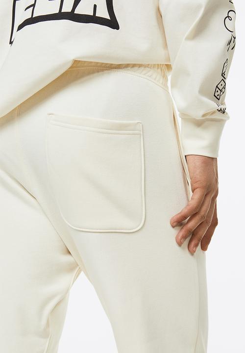 H&M - Regular fit sweatpants - cream/felix the cat 