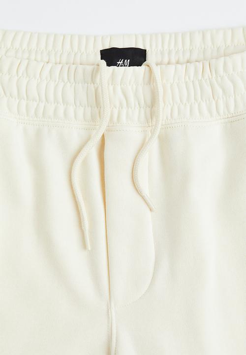 H&M - Regular fit sweatpants - cream/felix the cat 