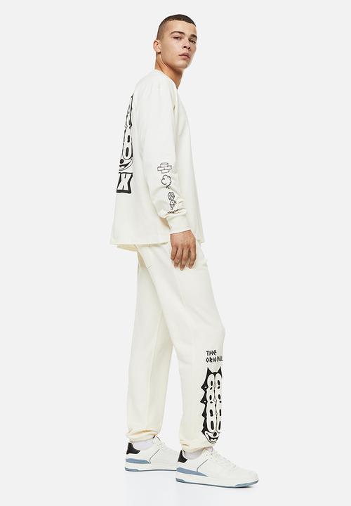 H&M - Regular fit sweatpants - cream/felix the cat 