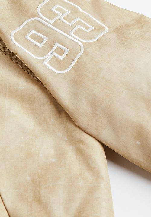 H&M - Embroidered baseball jacket - light beige/players 