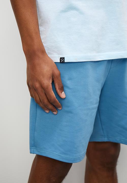 STYLE REPUBLIC - Slash raw edge curved hem pocket tee - light blue