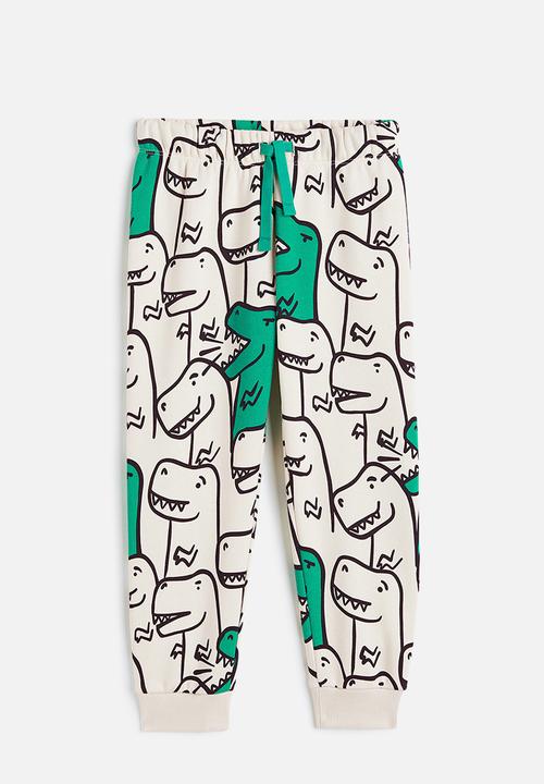 H&M - Printed joggers - light beige/dinosaurs 