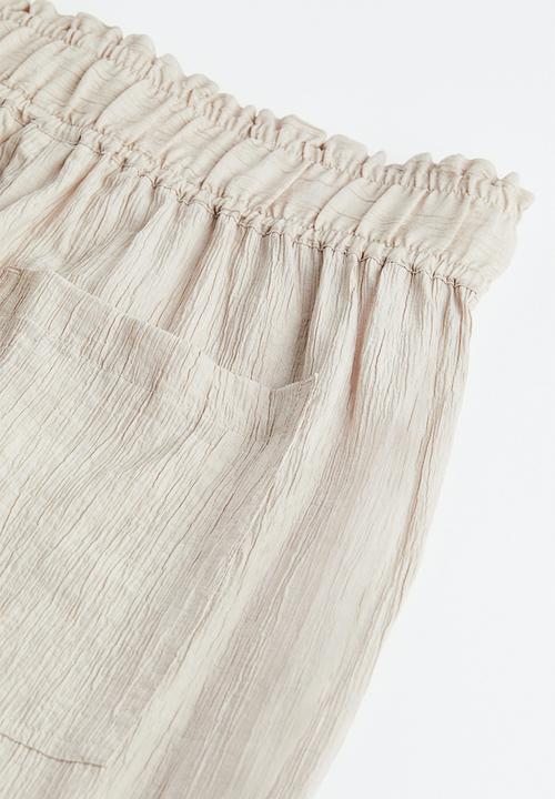 H&M - Tapered trousers - light beige 