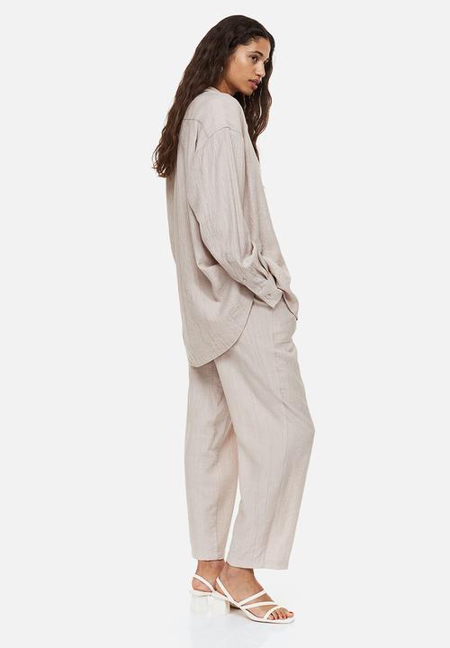 H&M - Tapered trousers - light beige 