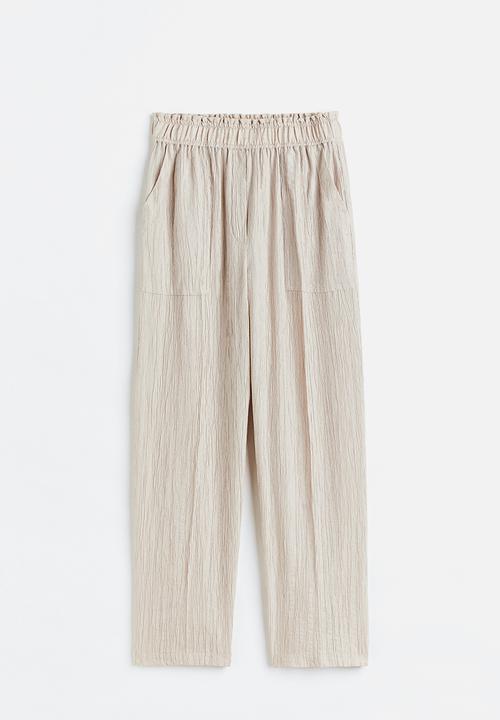 H&M - Tapered trousers - light beige 