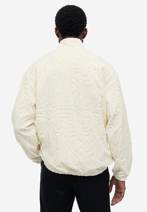 H&M - Relaxed fit terry track jacket - cream keith haring 