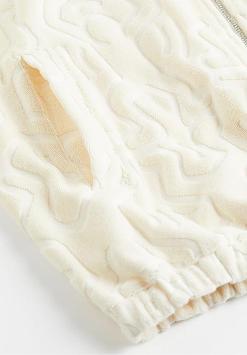 H&M - Relaxed fit terry track jacket - cream keith haring 