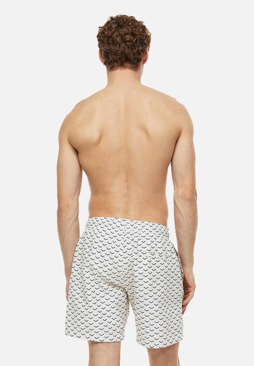 H&M - Patterned swim shorts - light beige patterned