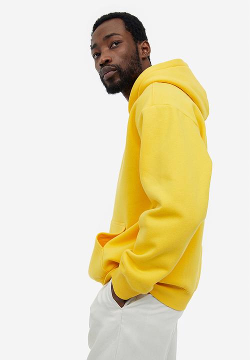 H&M - Relaxed fit hoodie - yellow keith haring