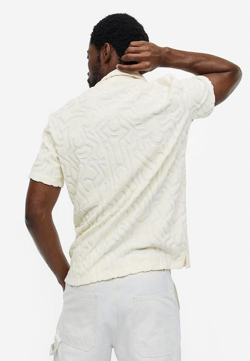 H&M - Regular fit terry polo shirt - cream keith haring