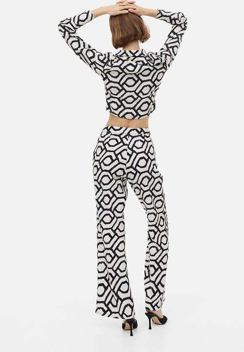 H&M - Flared trousers - cream patterned 
