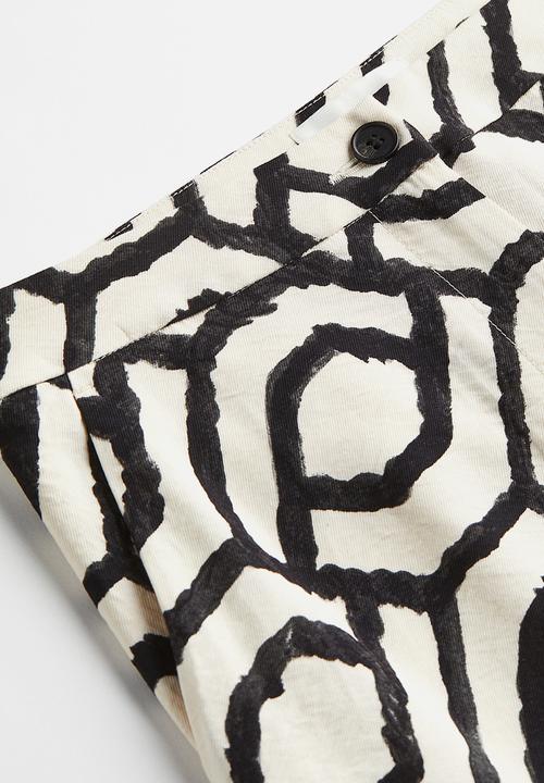 H&M - Flared trousers - cream patterned 