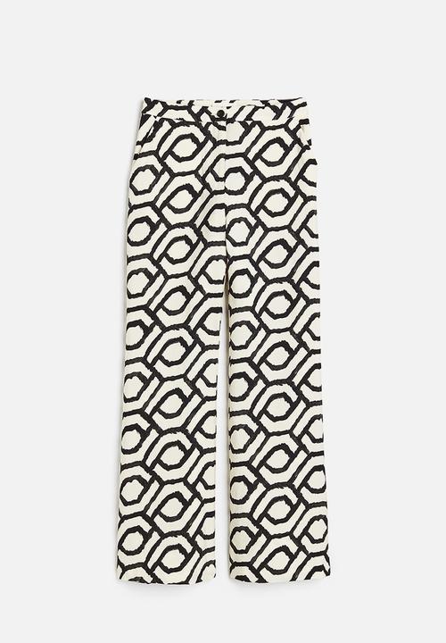 H&M - Flared trousers - cream patterned 