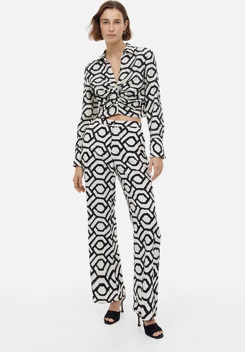 H&M - Flared trousers - cream patterned 