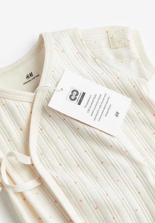H&M - Wrapover cotton romper suit - white / spotted 