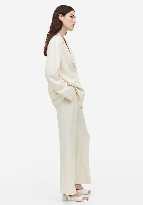 H&M - Flared viscose trousers - cream 