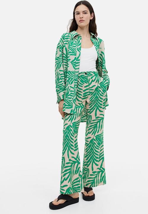 H&M - Flared trousers - light beige leaf-patterned 