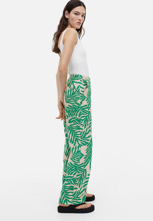 H&M - Flared trousers - light beige leaf-patterned 