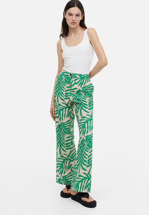 H&M - Flared trousers - light beige leaf-patterned 