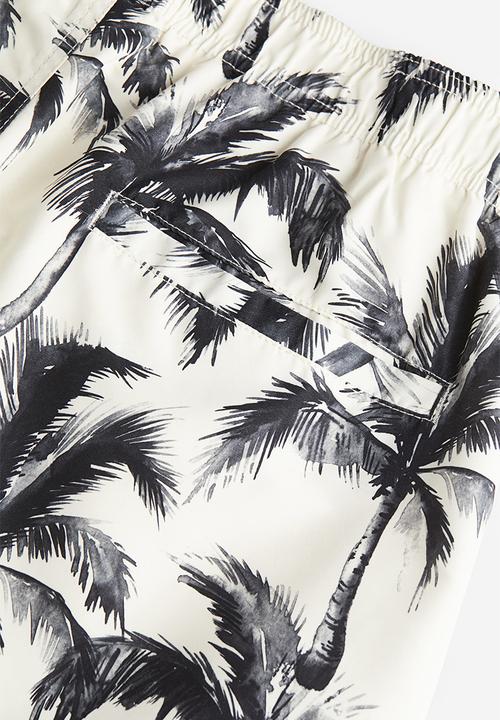 H&M - Patterned swim shorts - white palm trees