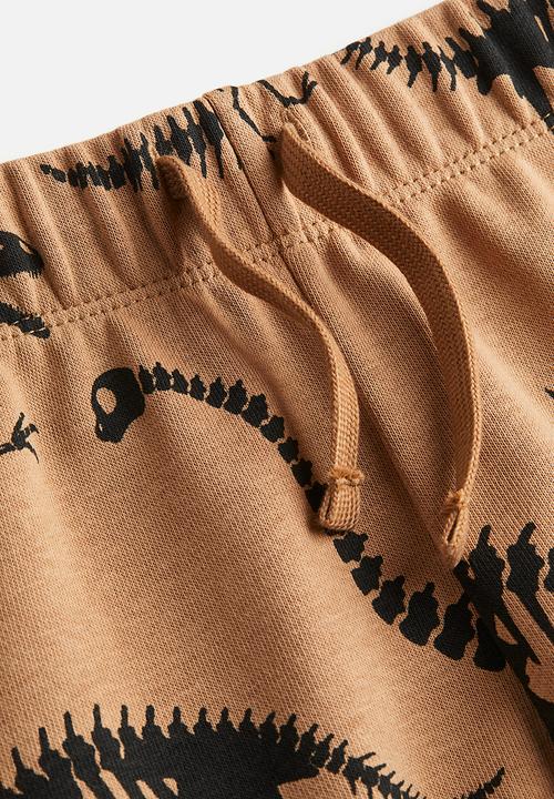 H&M - Sweatshirt shorts - dark beige/dinosaurs