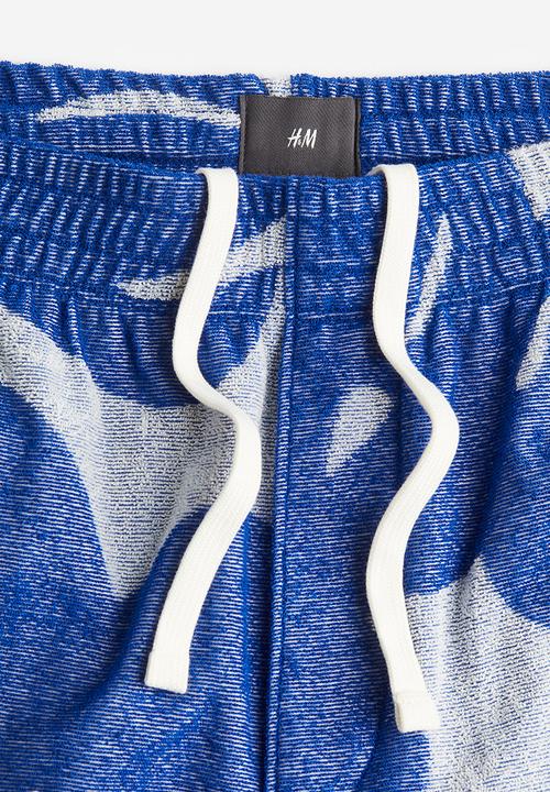 H&M - Regular fit terry shorts - blue leaf-patterned 
