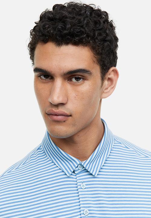 H&M - Slim fit polo shirt - blue/light blue striped