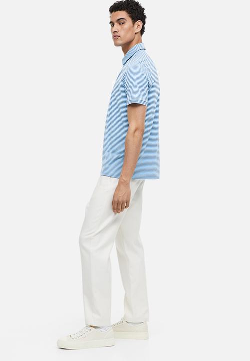 H&M - Slim fit polo shirt - blue/light blue striped