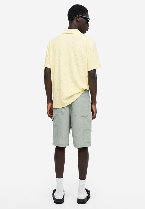 H&M - Regular fit terry polo shirt - yellow & smiley®