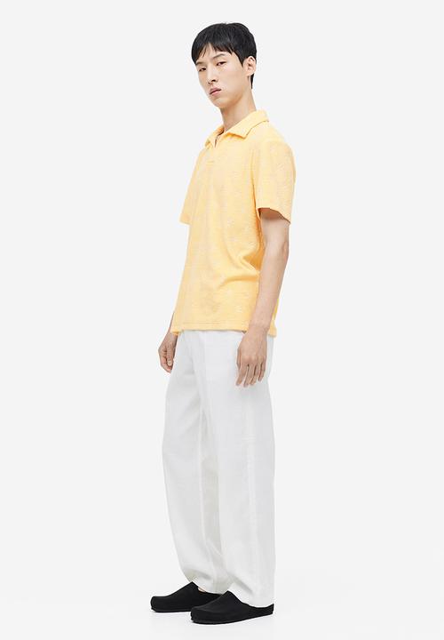 H&M - Regular fit terry polo shirt - yellow/palm trees