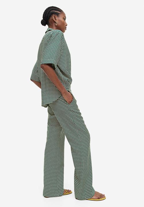 H&M - Flared trousers - dark green & patterned