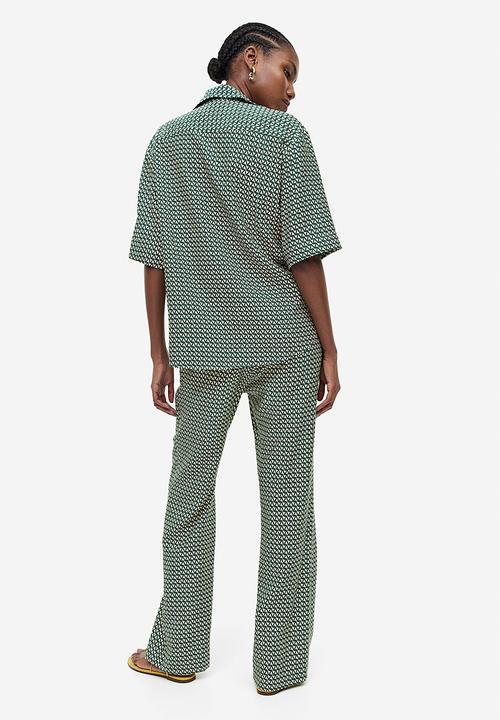H&M - Flared trousers - dark green & patterned
