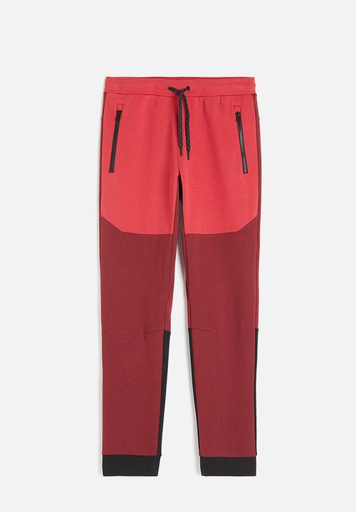 H&M - Drymove™ tapered tech joggers with zipped pockets - red