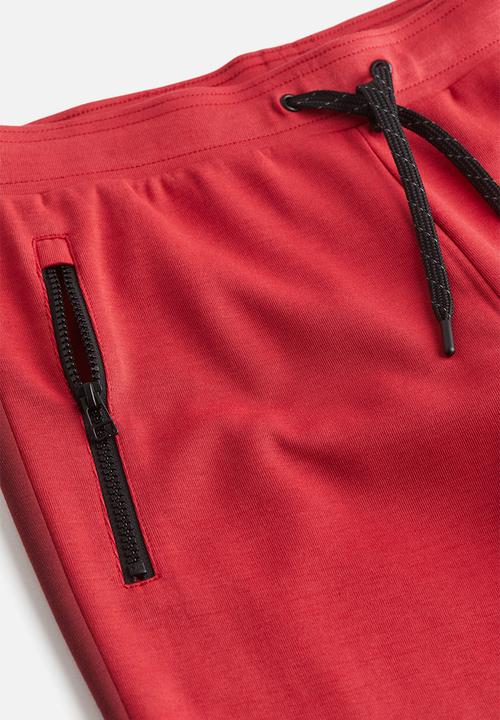H&M - Drymove™ tapered tech joggers with zipped pockets - red