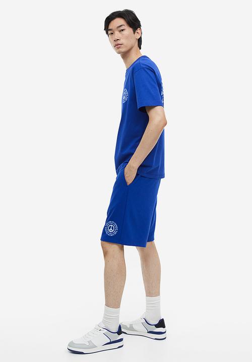H&M - Coolmax® loose fit sweatshorts - Bright blue Peace symbol