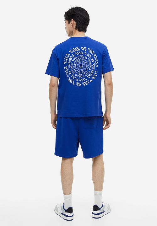 H&M - Coolmax® loose fit sweatshorts - Bright blue Peace symbol
