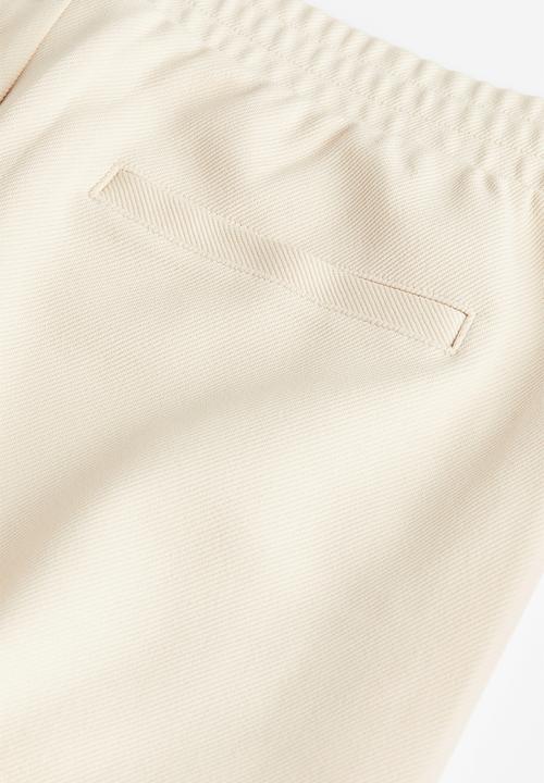 H&M - Slim fit twill joggers - beige white