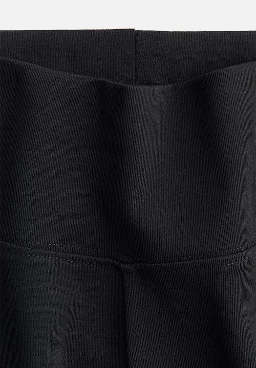 H&M - Flared leggings - black/ribbed