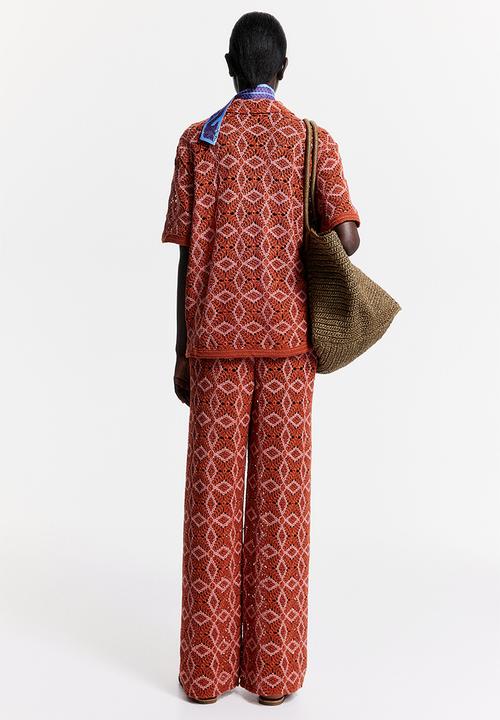 H&M - THE WHITE LOTUS H&M - Crocheted trousers - orange patterned 