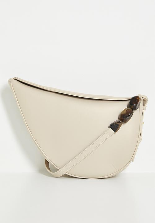 Tessa Design - Crescent shaped shoulder bag with beaded strap detail - cream