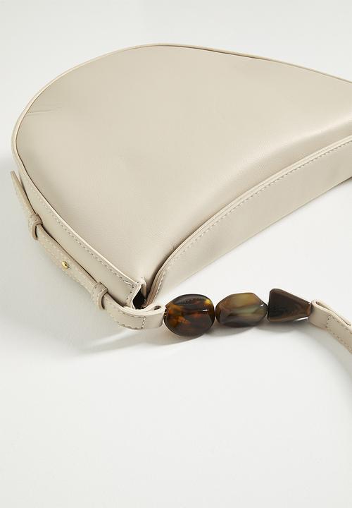 Tessa Design - Crescent shaped shoulder bag with beaded strap detail - cream