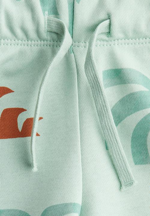 H&M - Printed sweatshorts - light turquoise/palm trees 