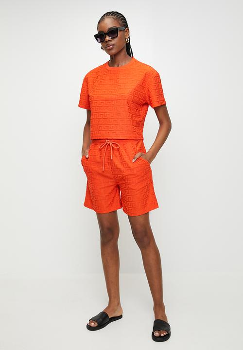 Steve Madden - Ladies bella embossed logo jogger shorts - tangerine