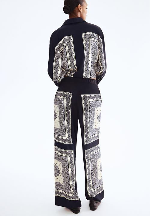 H&M - Straight trousers - navy blue/patterned 