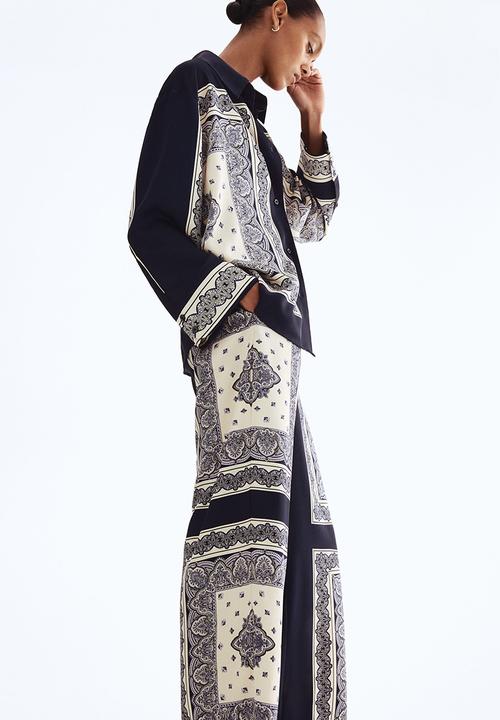 H&M - Straight trousers - navy blue/patterned 
