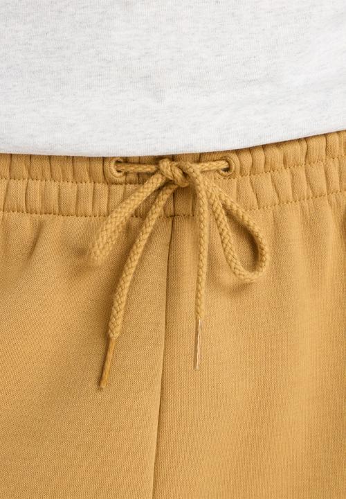 New Balance  - New Balance Linear Graphic Brushed Fleece Pant - Brown