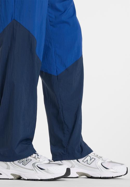 New Balance  - NB Athletics Sport Legacy Pant - Blue
